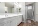 Double vanity bathroom with a large mirror and shower at 30255 N 115Th Dr, Peoria, AZ 85383