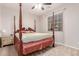 Second bedroom with a four-poster bed at 30255 N 115Th Dr, Peoria, AZ 85383