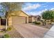 Front view of a house with a two-car garage and desert landscaping at 30255 N 115Th Dr, Peoria, AZ 85383