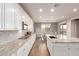 Open concept kitchen with white cabinets, granite counters and island at 30255 N 115Th Dr, Peoria, AZ 85383