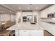 Modern kitchen with white cabinets, granite countertops and large island at 30255 N 115Th Dr, Peoria, AZ 85383