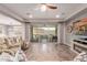 Living room with sliding glass doors, fireplace, and views of the pool and landscape at 30255 N 115Th Dr, Peoria, AZ 85383