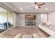 Living room with a fireplace and sliding glass doors leading to the backyard at 30255 N 115Th Dr, Peoria, AZ 85383