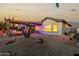 Desert landscape with covered patio, outdoor kitchen, and seating area at 30792 N Orange Blossom Cir, San Tan Valley, AZ 85143