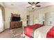 Bedroom with large dresser, TV stand, and ceiling fan at 30792 N Orange Blossom Cir, San Tan Valley, AZ 85143