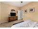 Bedroom with TV, dresser, and adjacent bathroom at 30792 N Orange Blossom Cir, San Tan Valley, AZ 85143