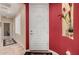 Bright entryway with a white door, red accent wall, and tile flooring at 30792 N Orange Blossom Cir, San Tan Valley, AZ 85143