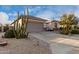 House exterior showcasing desert landscaping and a two-car garage at 30792 N Orange Blossom Cir, San Tan Valley, AZ 85143