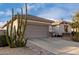 Front yard with cacti and a two-car garage at 30792 N Orange Blossom Cir, San Tan Valley, AZ 85143