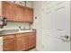 Laundry room with sink, cabinets and door at 30792 N Orange Blossom Cir, San Tan Valley, AZ 85143