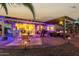 Evening view of a covered patio with dining and seating areas at 30792 N Orange Blossom Cir, San Tan Valley, AZ 85143