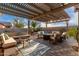 Relaxing covered patio with seating area and fire pit at 30792 N Orange Blossom Cir, San Tan Valley, AZ 85143