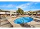 Community pool with surrounding lounge chairs and spa at 3301 E Earll Dr # 102, Phoenix, AZ 85018