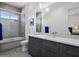 Modern bathroom with gray vanity, a soaking tub, and stylish tile at 33214 N 14Th St, Phoenix, AZ 85085