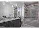 Modern bathroom with gray vanity, soaking tub, and tile shower at 33214 N 14Th St, Phoenix, AZ 85085