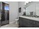 Bathroom with gray vanity, a walk-in shower, and pebble tile at 33214 N 14Th St, Phoenix, AZ 85085