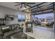 Game room with sliding glass doors opening to a pool and mountain view at 33214 N 14Th St, Phoenix, AZ 85085