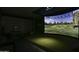 High-tech golf simulator in a finished garage space at 33214 N 14Th St, Phoenix, AZ 85085