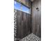 Walk-in shower with gray tile and pebble accents at 33214 N 14Th St, Phoenix, AZ 85085