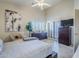 Bedroom with king-size bed, dresser, and access to private balcony at 3324 E Maldonado Dr, Phoenix, AZ 85042