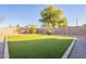 Artificial turf backyard with gravel and shrubs at 34403 N Damietta Trl, San Tan Valley, AZ 85143