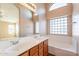 Bathroom boasts double sinks, soaking tub, and block window at 34403 N Damietta Trl, San Tan Valley, AZ 85143