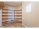 Spacious pantry with ample shelving for storage at 34403 N Damietta Trl, San Tan Valley, AZ 85143