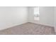 Bright bedroom featuring a large window and neutral carpeting at 36711 W Harrison St, Tonopah, AZ 85354