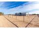 Single-story home with gray siding and a fenced yard at 36711 W Harrison St, Tonopah, AZ 85354