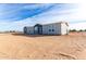 Single-story home with gray siding and fenced yard at 36711 W Harrison St, Tonopah, AZ 85354