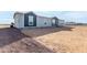 Single-story home with gray and blue siding at 36711 W Harrison St, Tonopah, AZ 85354