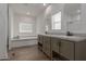 Modern bathroom with double vanity, soaking tub, and walk-in shower at 36735 W Harrison St, Tonopah, AZ 85354