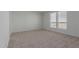 Spacious bedroom with carpeted floors and large window at 36735 W Harrison St, Tonopah, AZ 85354