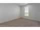 Simple bedroom with carpeted floor and window at 36735 W Harrison St, Tonopah, AZ 85354