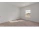 Well-lit bedroom featuring carpeted floors and a window at 36735 W Harrison St, Tonopah, AZ 85354