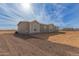 Grey manufactured home on a large lot at 36735 W Harrison St, Tonopah, AZ 85354