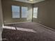 Bright bedroom with neutral wall colors and carpeted floor at 36850 W Nola Way, Maricopa, AZ 85138