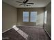 Large bedroom with ceiling fan and carpeted floor at 36850 W Nola Way, Maricopa, AZ 85138