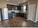 Kitchen with dark wood cabinets, granite countertops, and stainless steel appliances at 36850 W Nola Way, Maricopa, AZ 85138