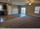 Open living and kitchen area with vinyl plank and carpet flooring at 36850 W Nola Way, Maricopa, AZ 85138