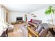 Bright living room with leather furniture and large TV at 3750 W Marshall Ave, Phoenix, AZ 85019