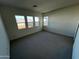 Bright bedroom with gray carpet and three large windows at 3752 W Antelope Way, San Tan Valley, AZ 85144