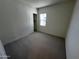 Simple bedroom with gray carpet and a large window at 3752 W Antelope Way, San Tan Valley, AZ 85144