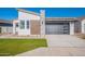 Modern home featuring a sleek, black garage door and manicured front lawn at 3752 W Antelope Way, San Tan Valley, AZ 85144