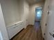 Bright hallway with white cabinets and wood-look flooring at 3752 W Antelope Way, San Tan Valley, AZ 85144