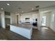 Modern kitchen with white cabinets, granite countertops, and a breakfast bar at 3752 W Antelope Way, San Tan Valley, AZ 85144