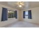 Bright bedroom with two windows and blue curtains at 3809 E Highland Ave, Phoenix, AZ 85018