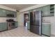 Kitchen with green cabinets, stainless steel appliances, and tile floors at 3809 E Highland Ave, Phoenix, AZ 85018