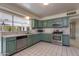 Kitchen boasts green cabinets and stainless steel appliances at 3809 E Highland Ave, Phoenix, AZ 85018