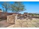 Outdoor kitchen, fireplace, and flagstone patio create a relaxing space at 40610 N Bradon Ct, Phoenix, AZ 85086